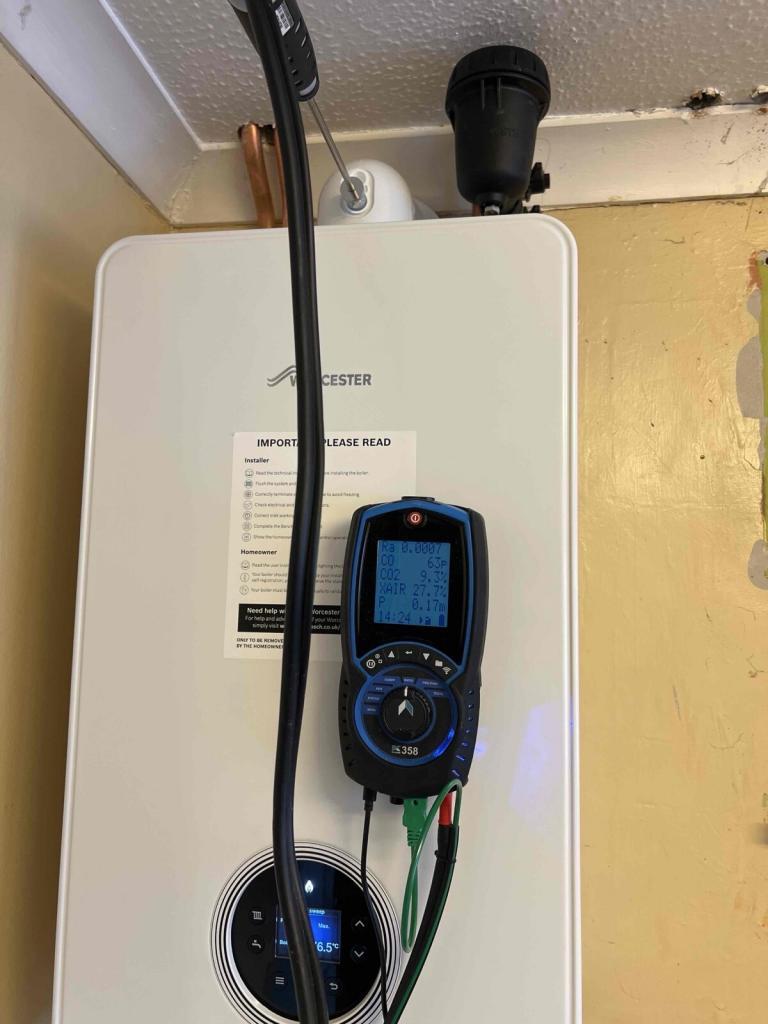 Gas Safe engineer servicing boiler in Epsom home