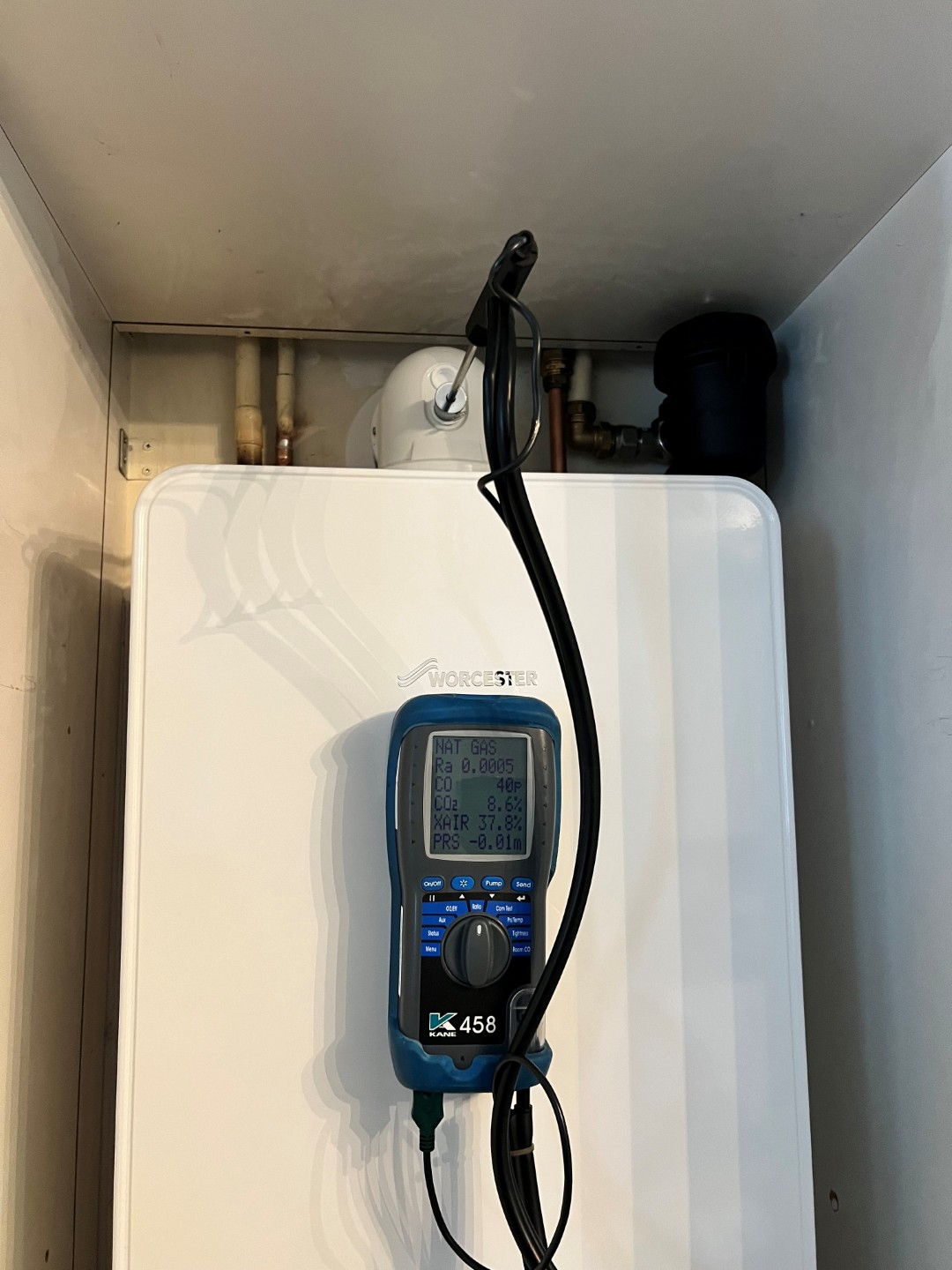 Gas Safe engineer testing boiler in Epsom